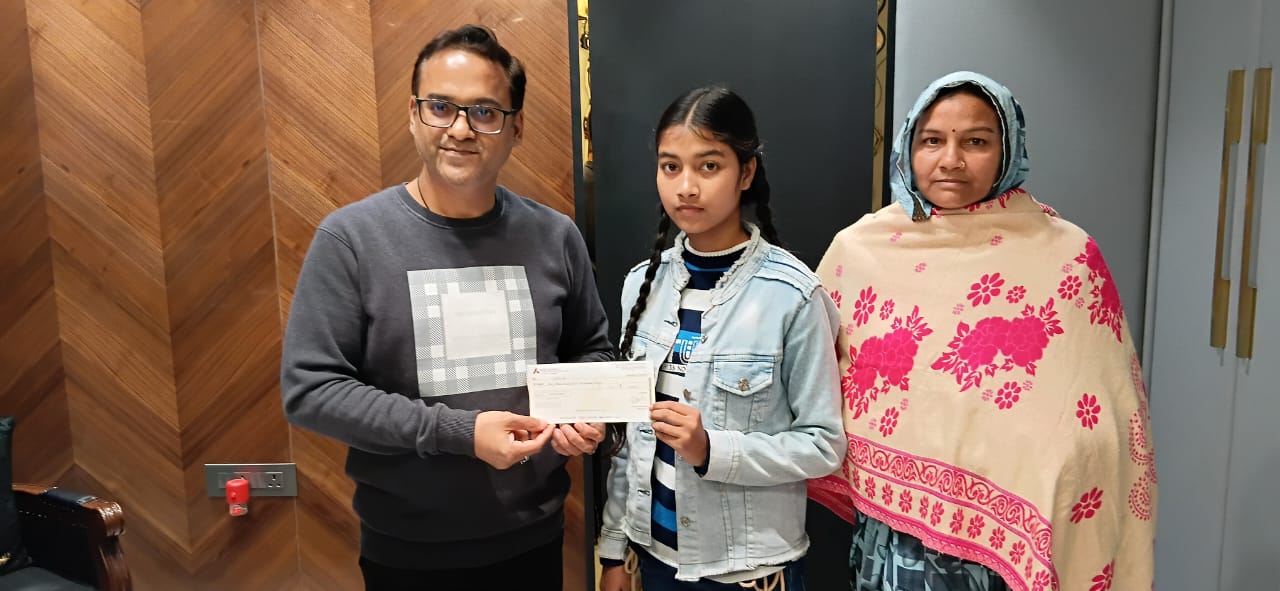 Scholarship award ceremony — student receiving cheque